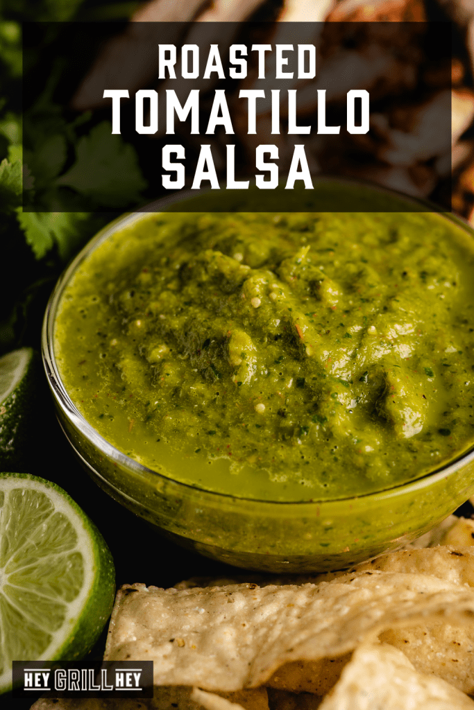 Roasted tomatillo salsa in a glass bowl with text overlay - Roasted Tomatillo Salsa.
