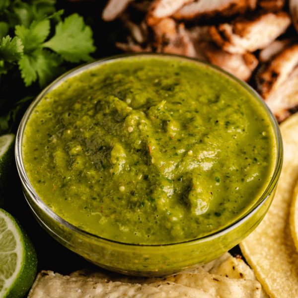 Roasted tomatillo salsa in a glass bowl.