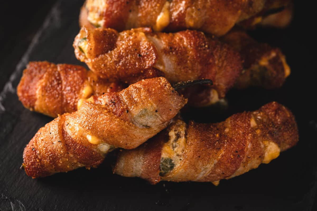 Smoked jalapeno poppers stacked on a serving platter.