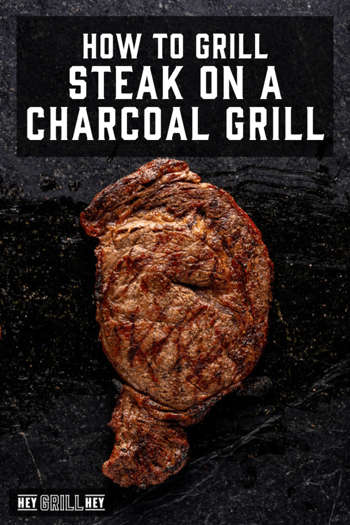 Grilled steak cooked on a charcoal grill.