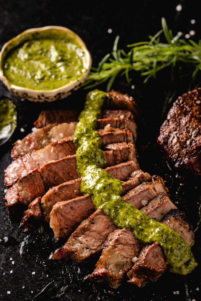 Steak covered with chimichurri sauce.
