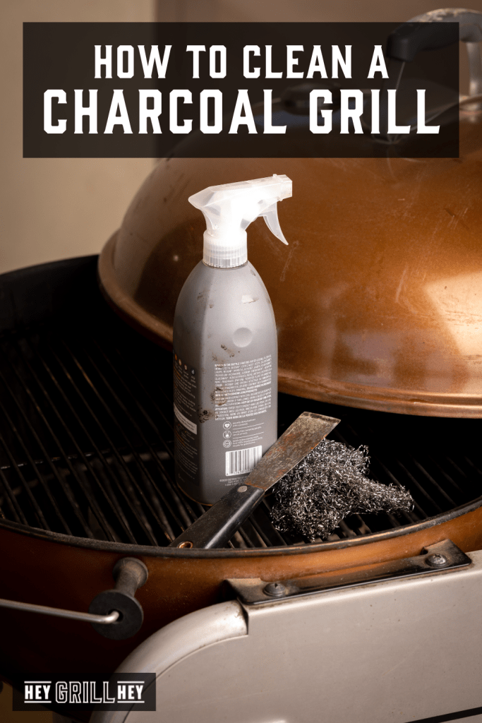 Cleaning utensils on a charcoal grill.