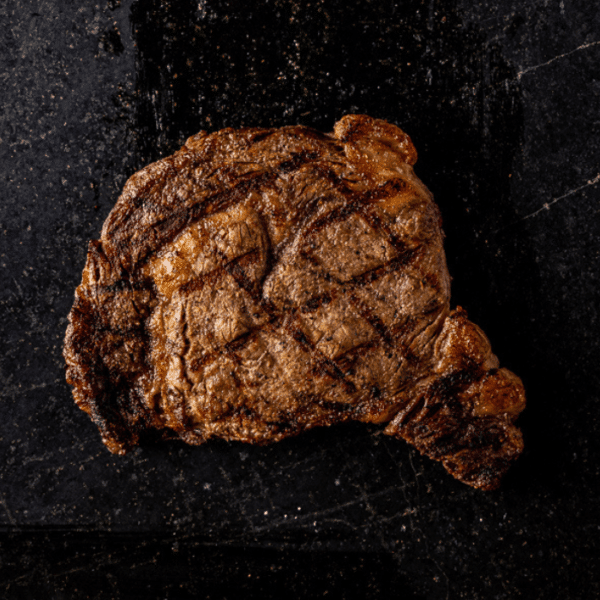 Propane grilled steak on a serving platter.