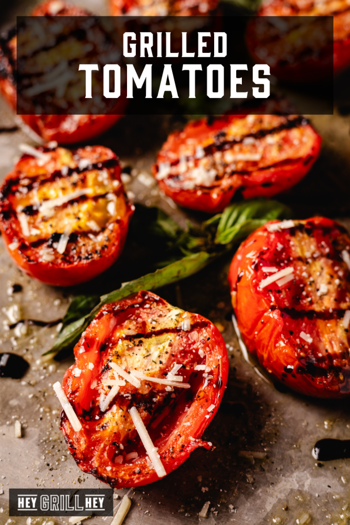 Grilled tomatoes on a serving platter with text overlay - Grilled Tomatoes.