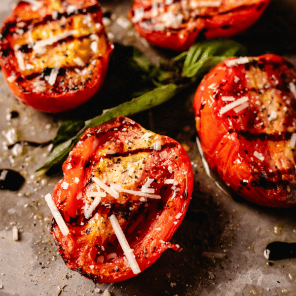 Grilled tomatoes on a serving platter.