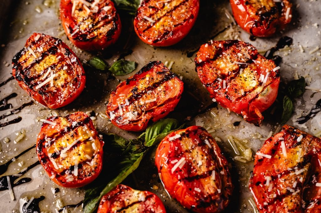 Grilled tomatoes on a serving platter.