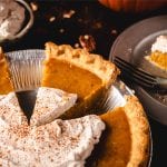 Pumpkin pie in tin with individual slice separated.