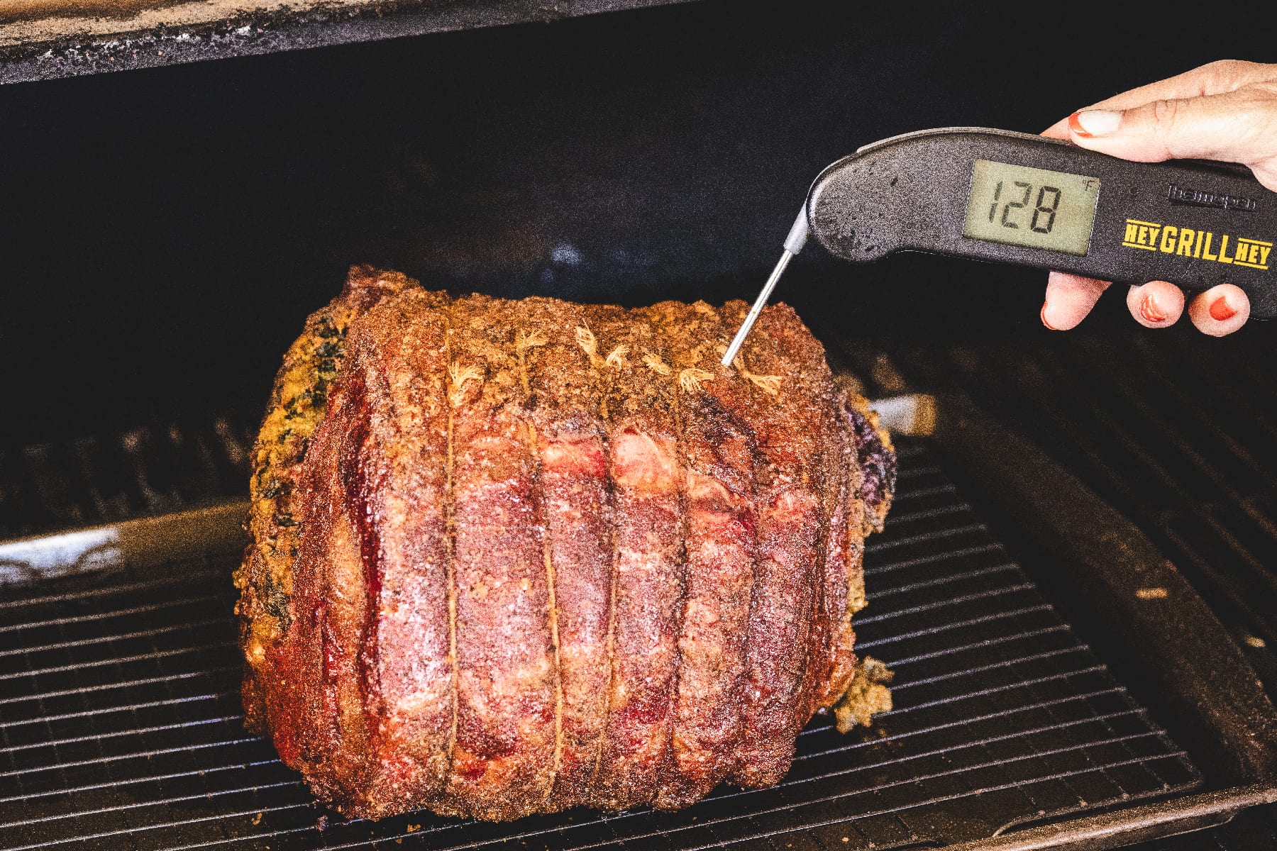 RIb roast on smoker with thermometer reading 128 degrees F.