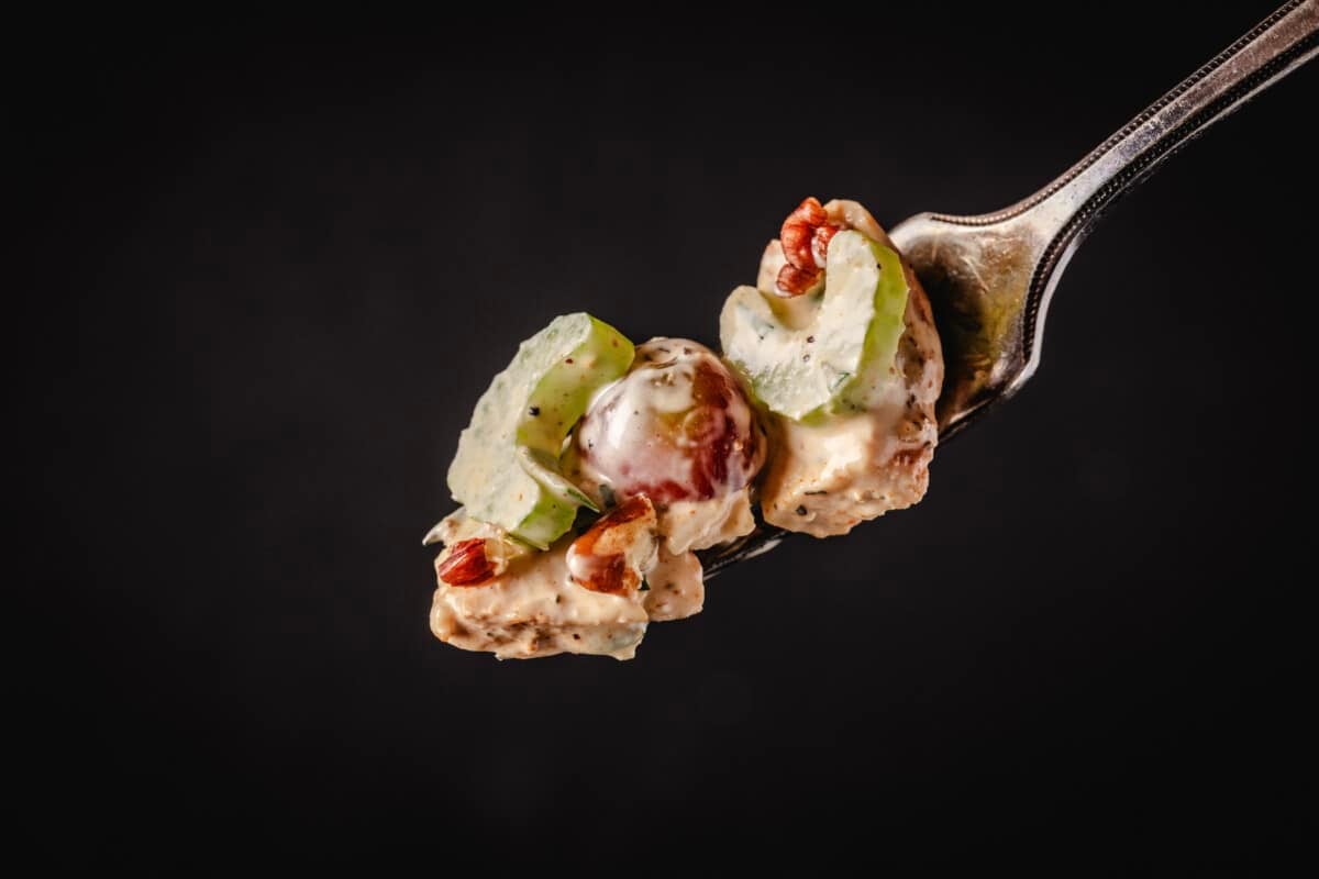 Smoked chicken salad on fork.