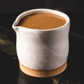 Au jus in white serving cup.