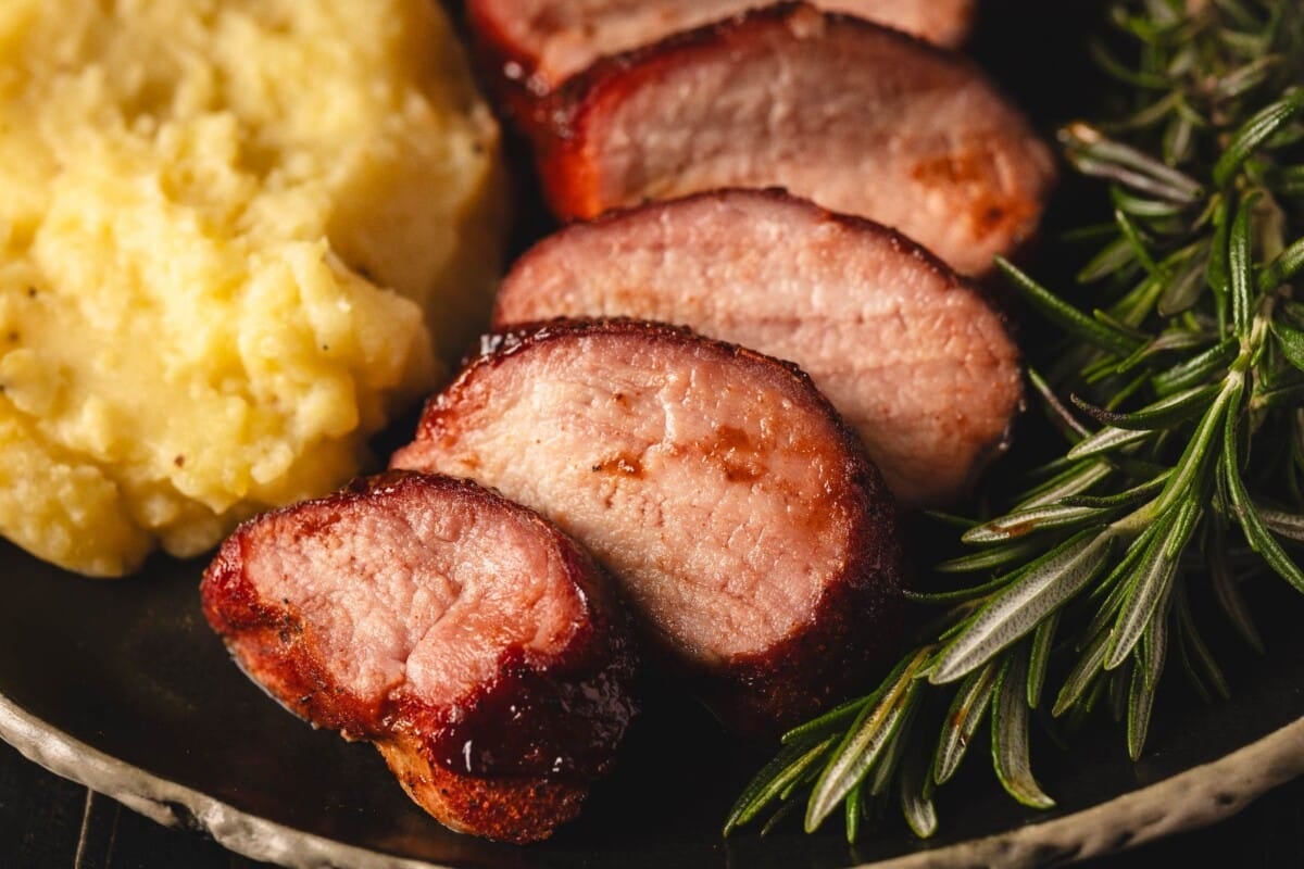 Slices of loom on the plate with mashed potatoes.