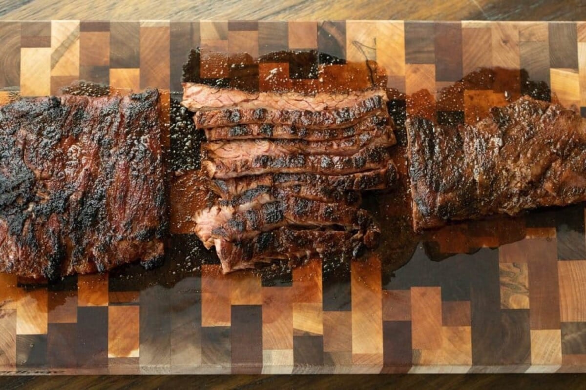 Sliced skirt beef on cutting board.