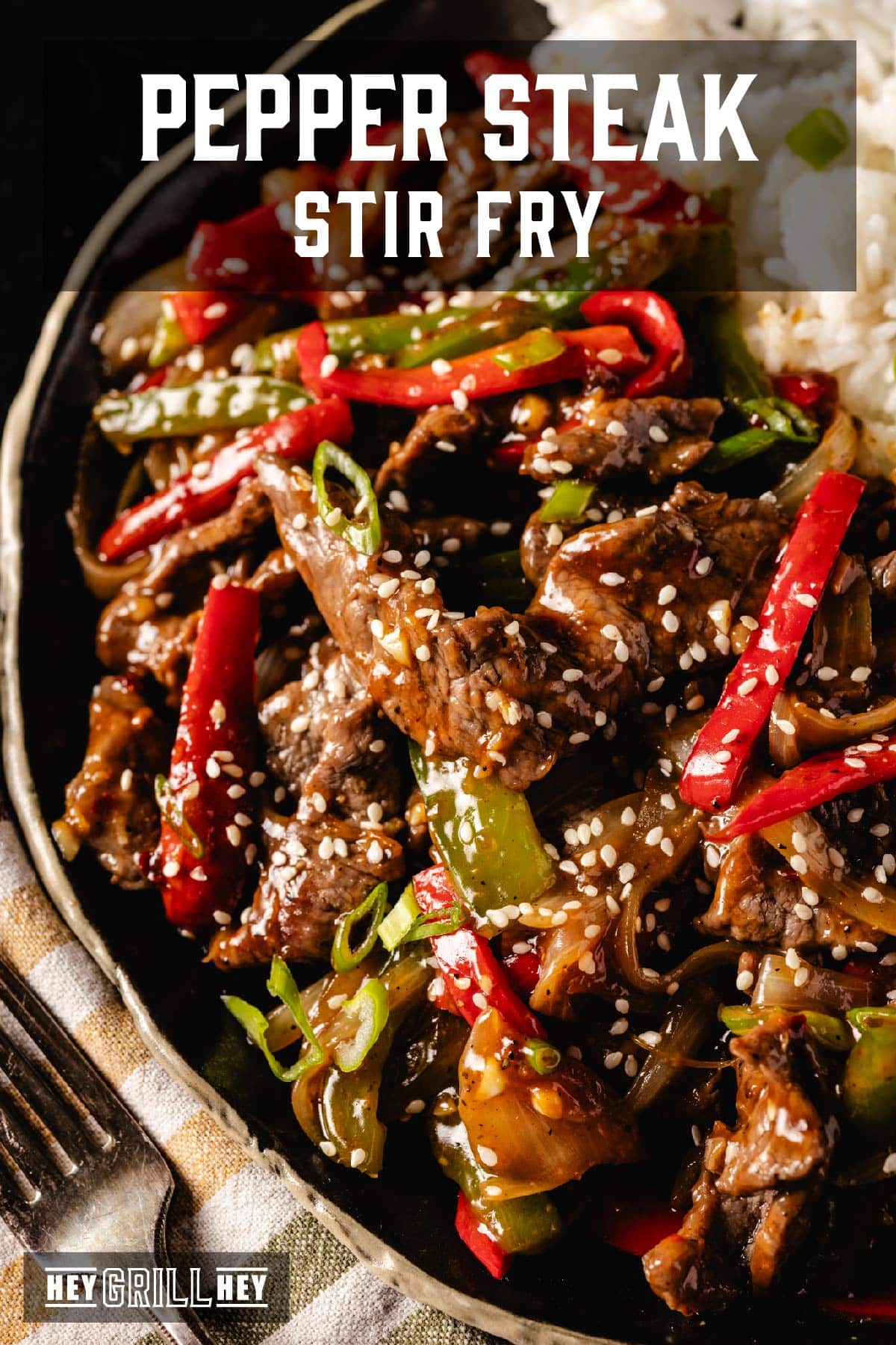 Pepper steak in bowl with rice. Text reads "Pepper Steak Stir Fry".