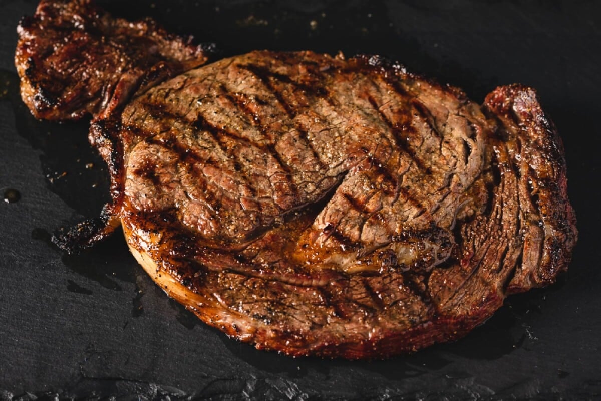 Grilled steak on cutting board.