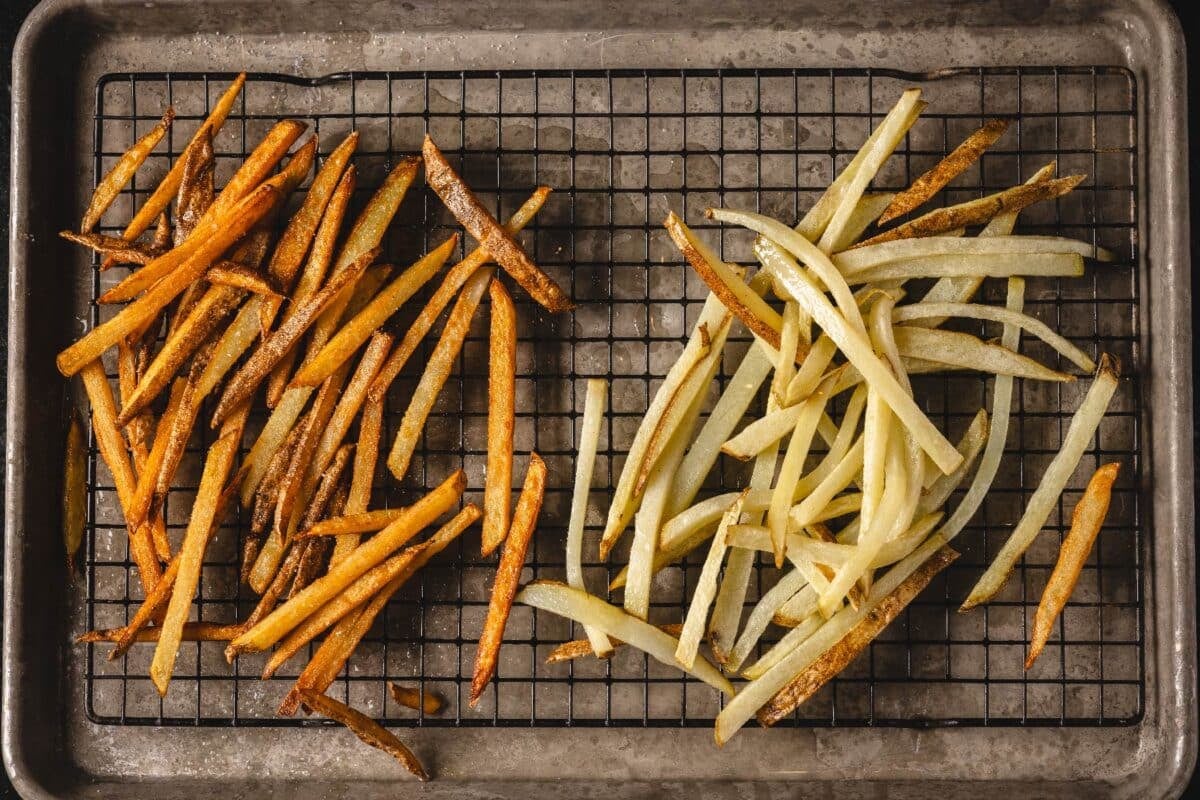 French fries and twice fried fires on drying rack.