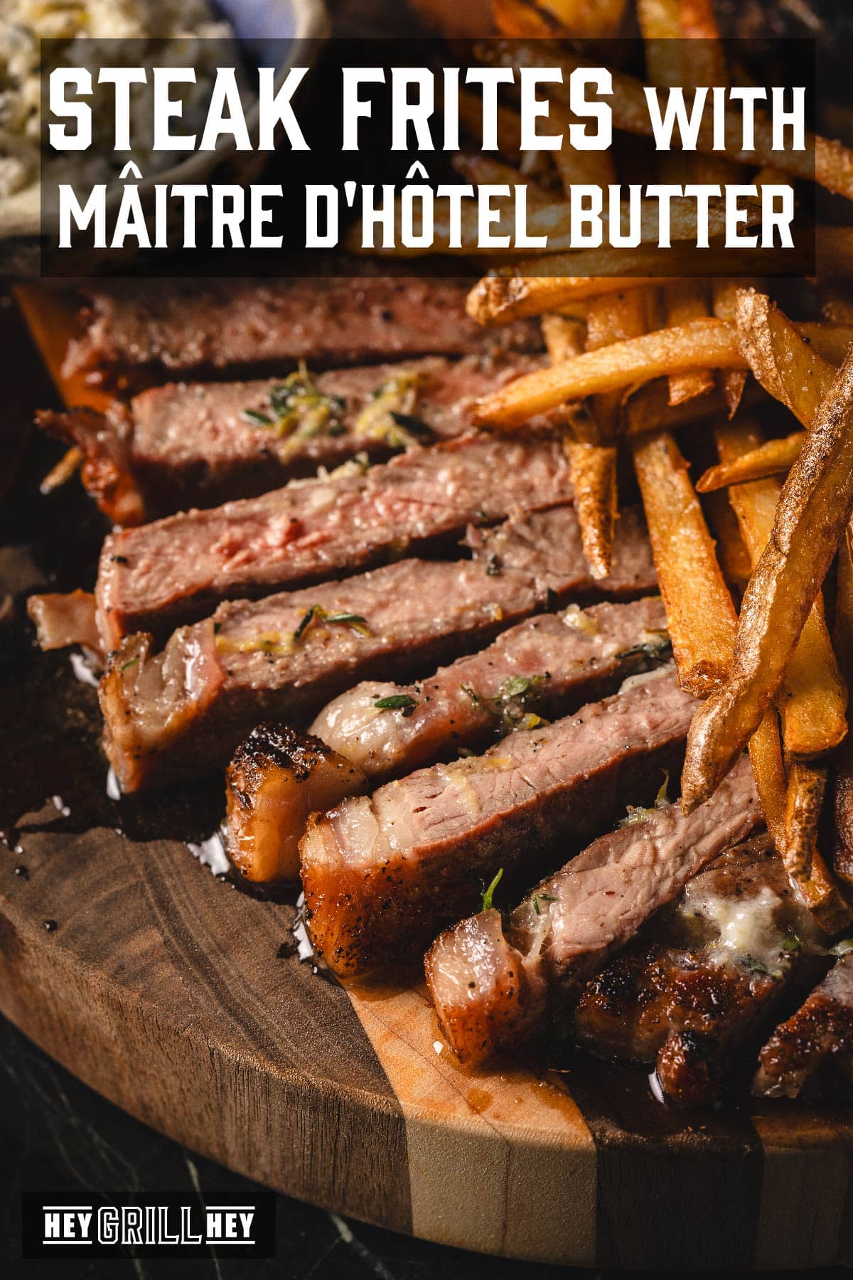 Sliced steak on serving platter with French fries. Text reads "Steak Frites with Mâitre d'Hôtel Butter".