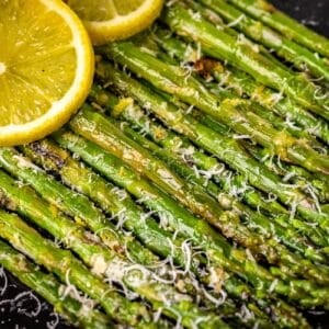 Grilled asparagus spears with lemon slices.