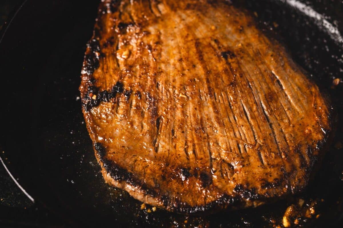 Steak searing in cast iron skillet.