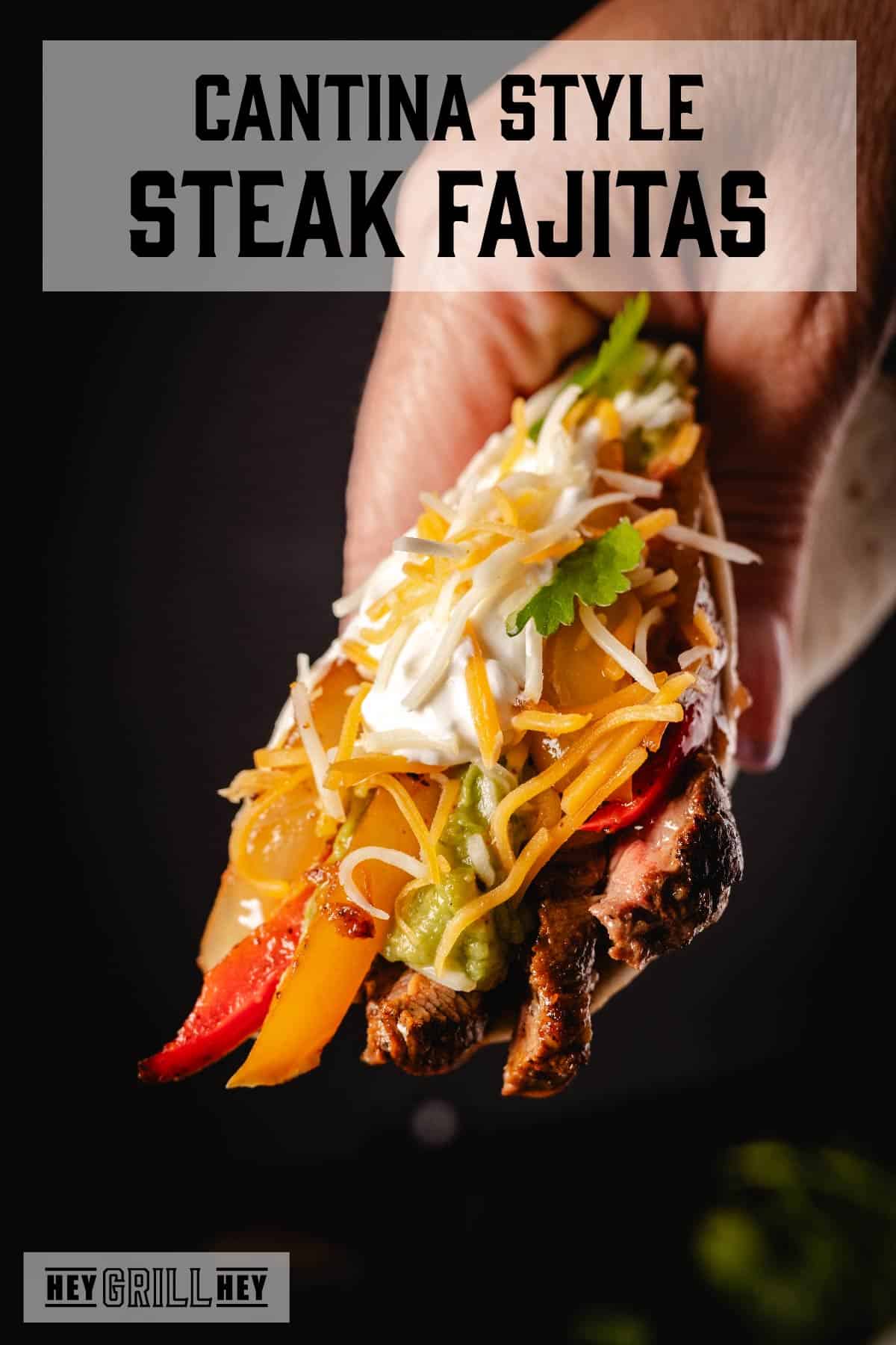 Hand holding up a loaded fajita. Text reads "Cantina Steak Fajitas".