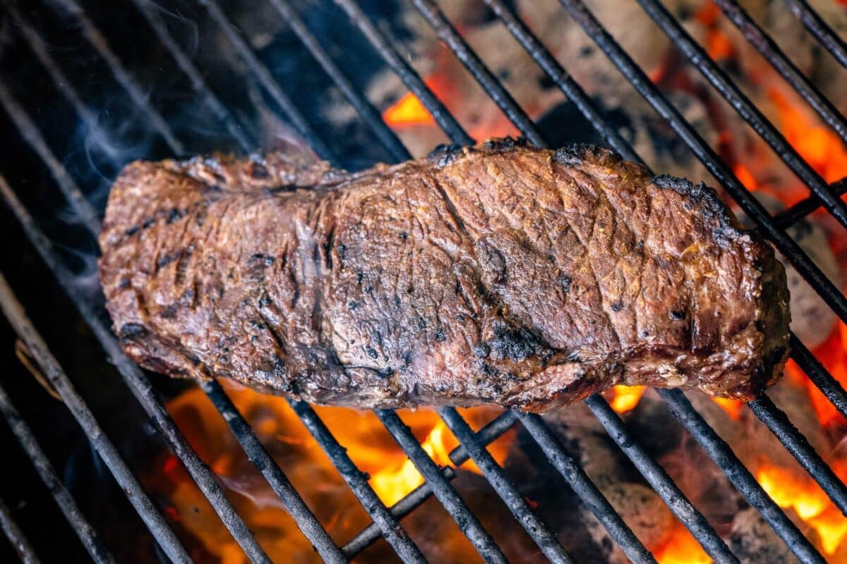 Grilled steak over hot charcoals.