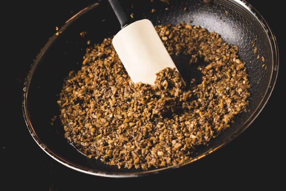 Seasoning being mixed with mortar and pestle.