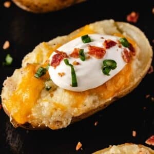Twice baked potato half topped with sour cream.