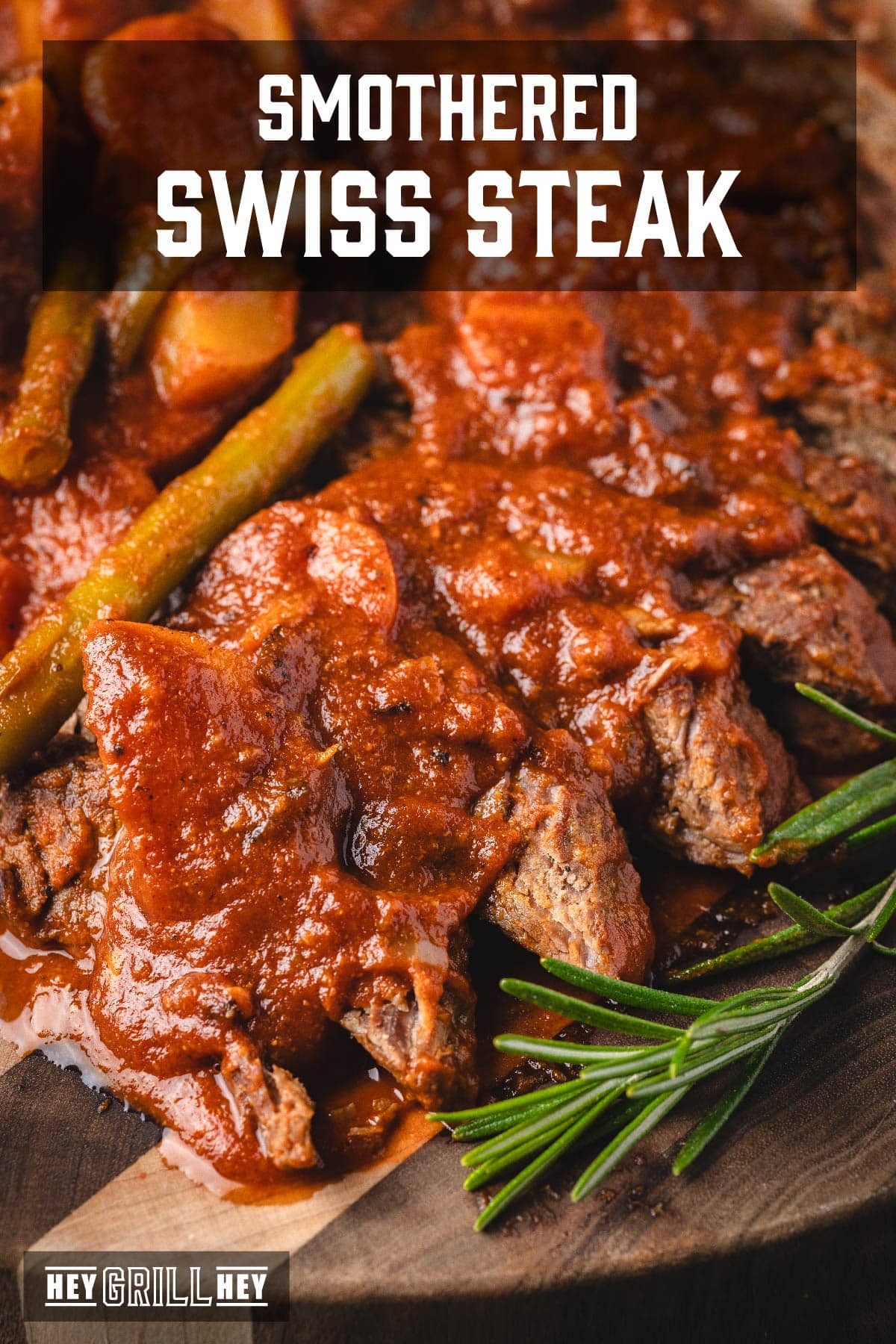 Steak topped with tomato braising liquid. Text reads "Smothered Swiss Steak".