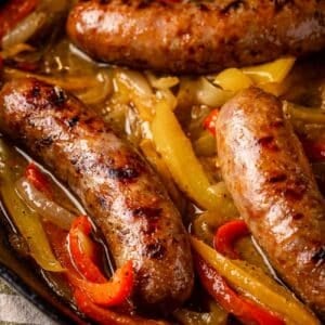 Sausage links in skillet with peppers.