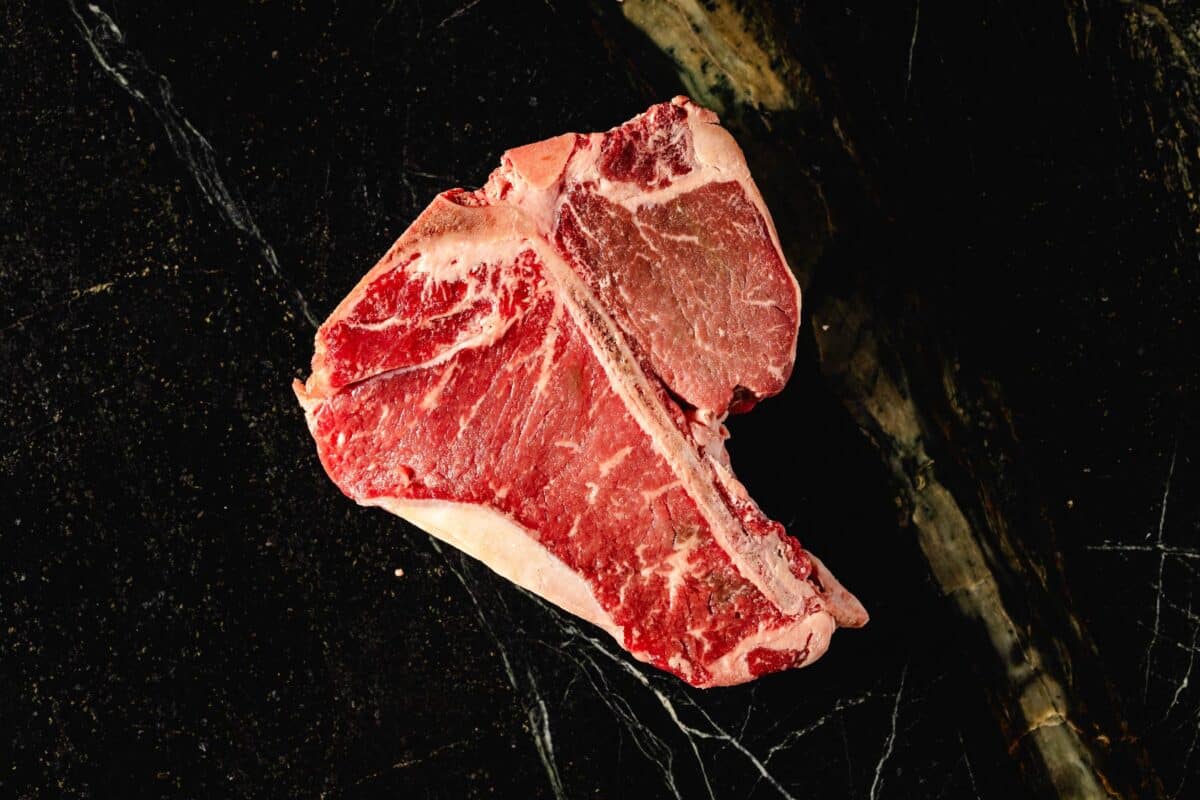 Raw steak on countertop.