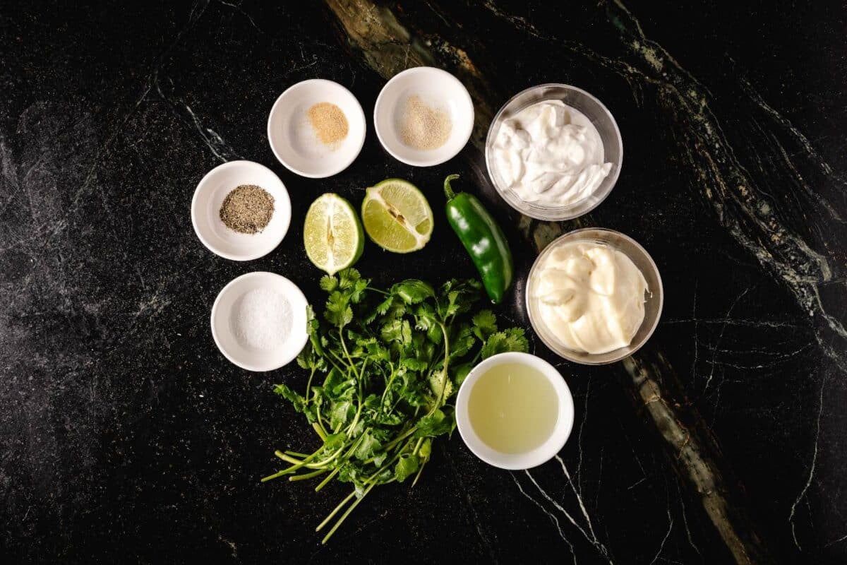 Various raw ingredients in glass bowls on countertop.