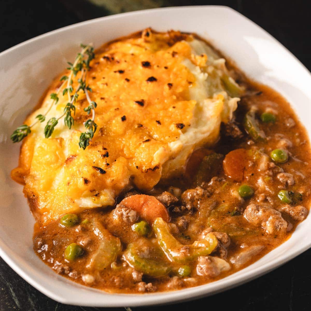 Cottage pie in a white, square bowl.