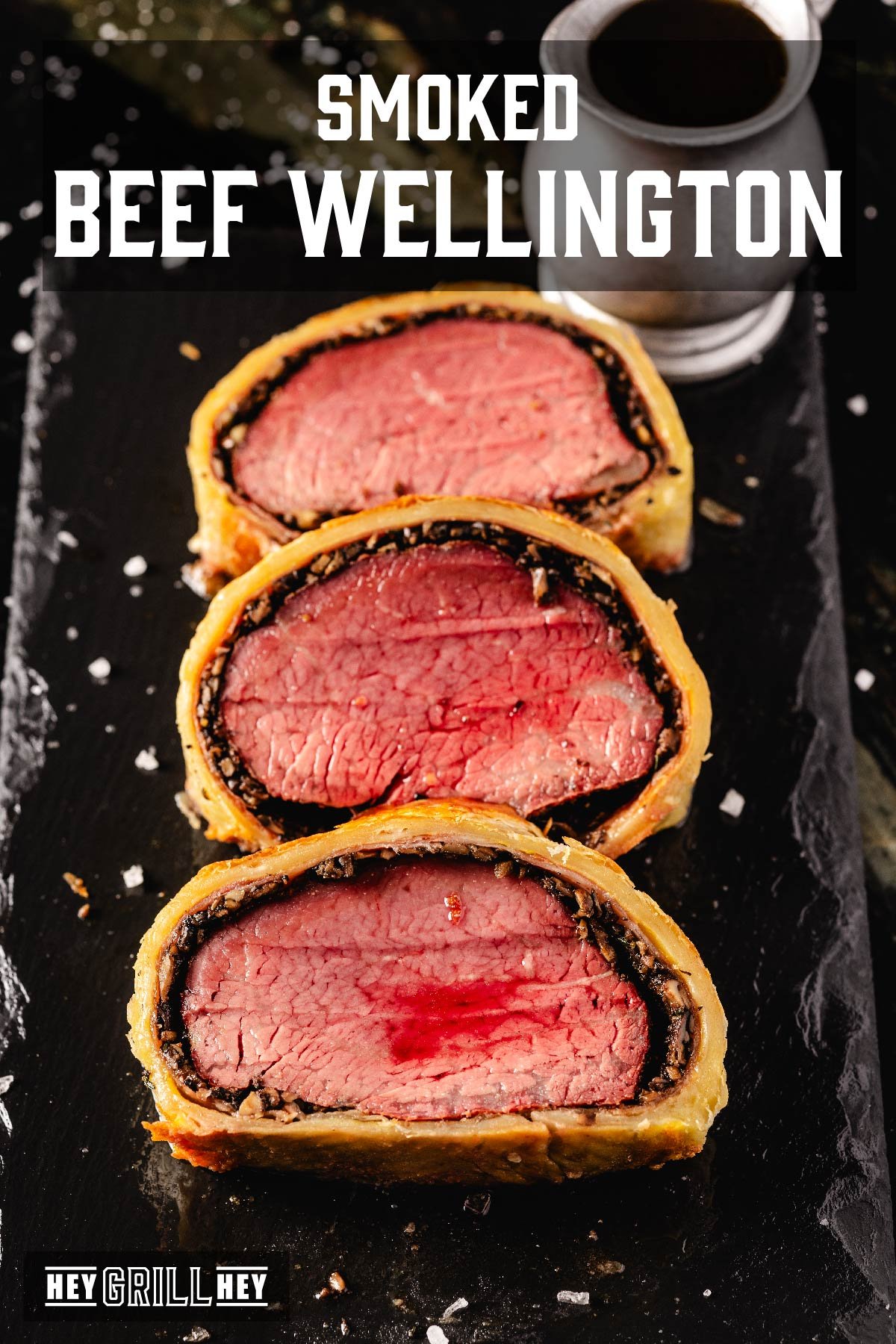 Sliced Beef Wellington on a black serving platter. Text reads "Smoked Beef Wellington".
