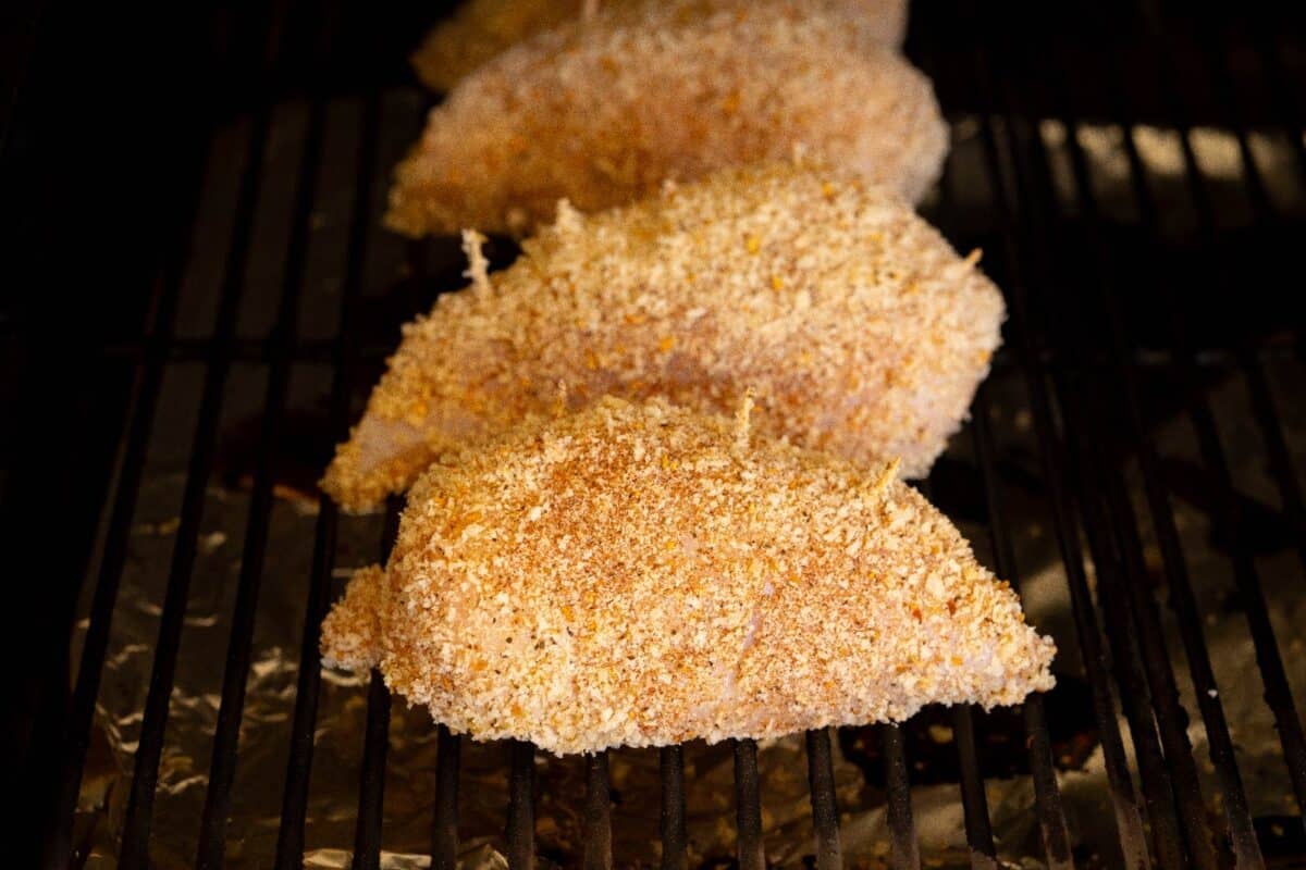 Chicken Cordon Bleu breasts on smoker grates.