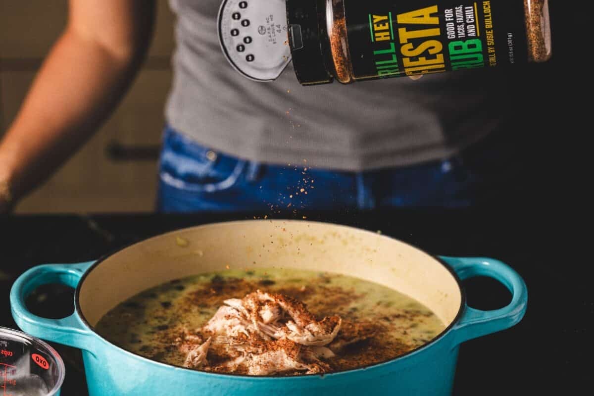 Fiesta Rub being sprinkled into a pot of chili.