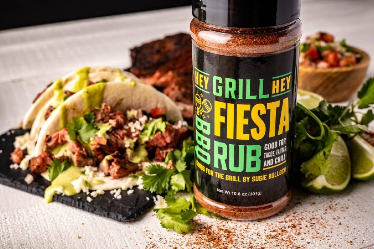 Bottle of Fiesta Rub next to a platter of tacos.