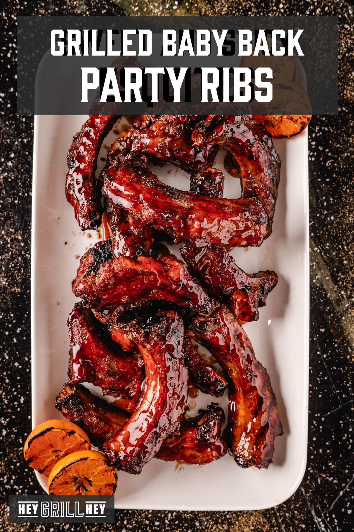 Sliced and glazed ribs on white plate with orange slices. Text reads "Grilled Baby Back Party Ribs".