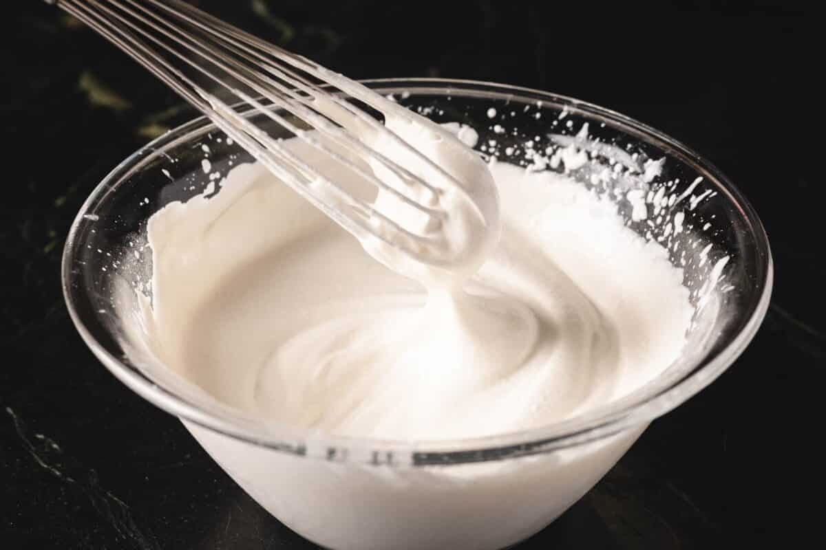 Whisk in glass bowl of whipped cream.