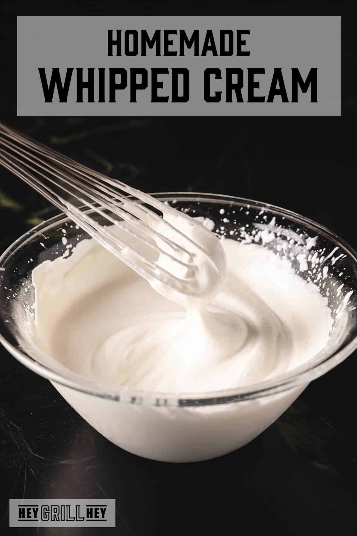 Glass bowl of whipped cream being whisked. Text reads "Homemade Whipped Cream".