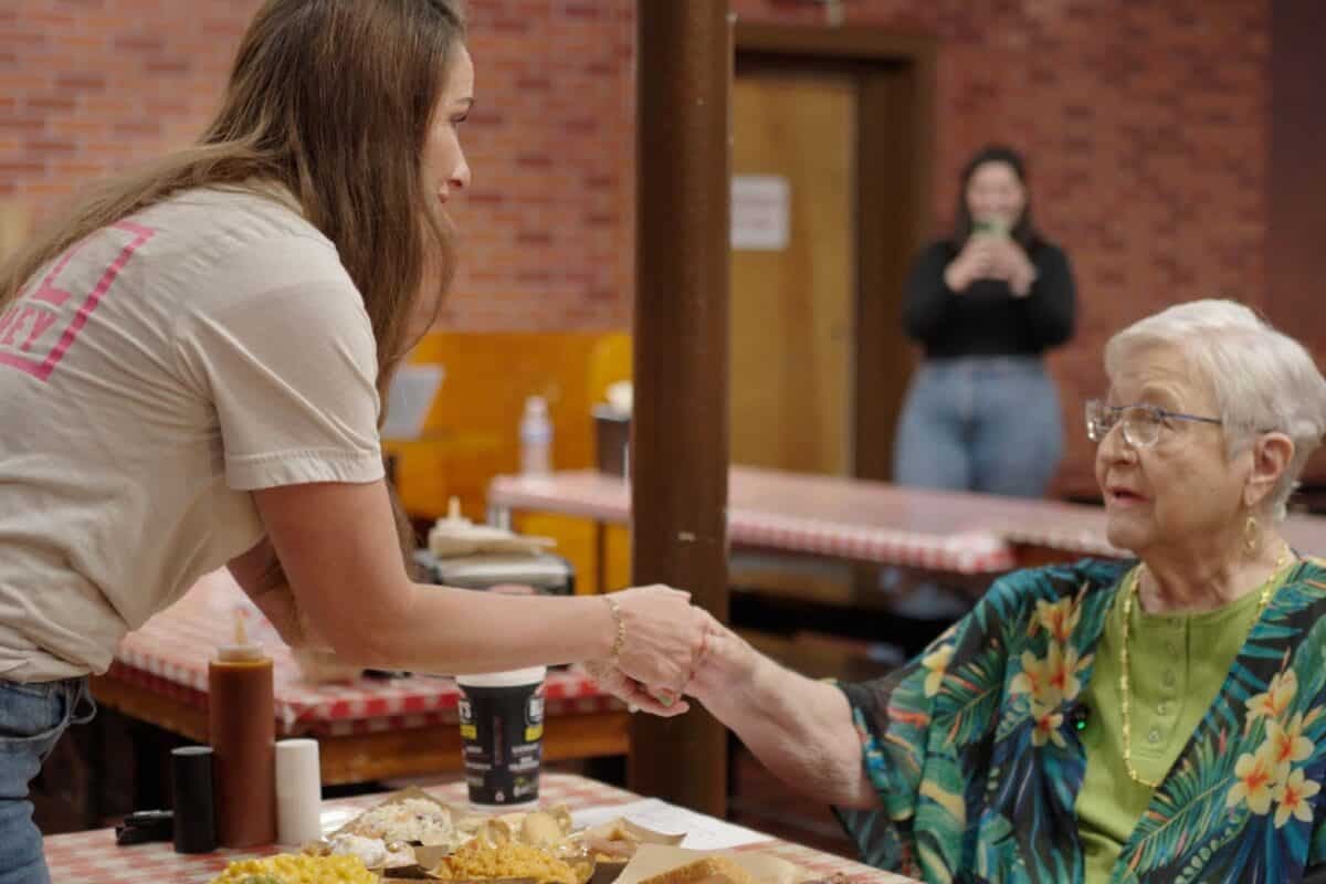 Susie meeting Norma Jean at a table in Black's Barbecue.