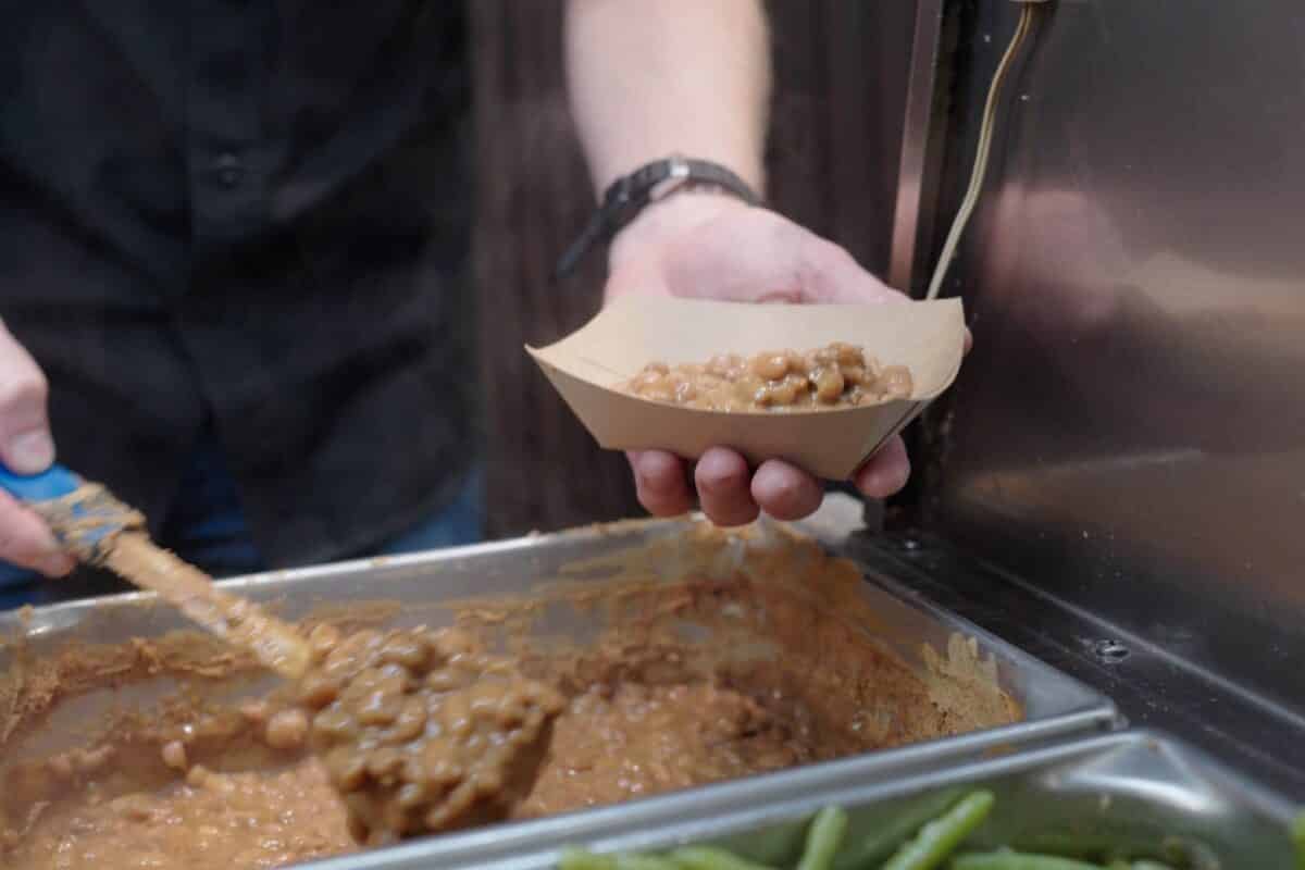 Norma Jean's famous pinto beans being scooped for serving.