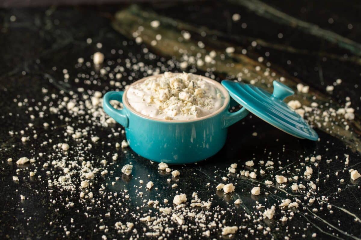 Blue cheese dressing in blue jar with lid.