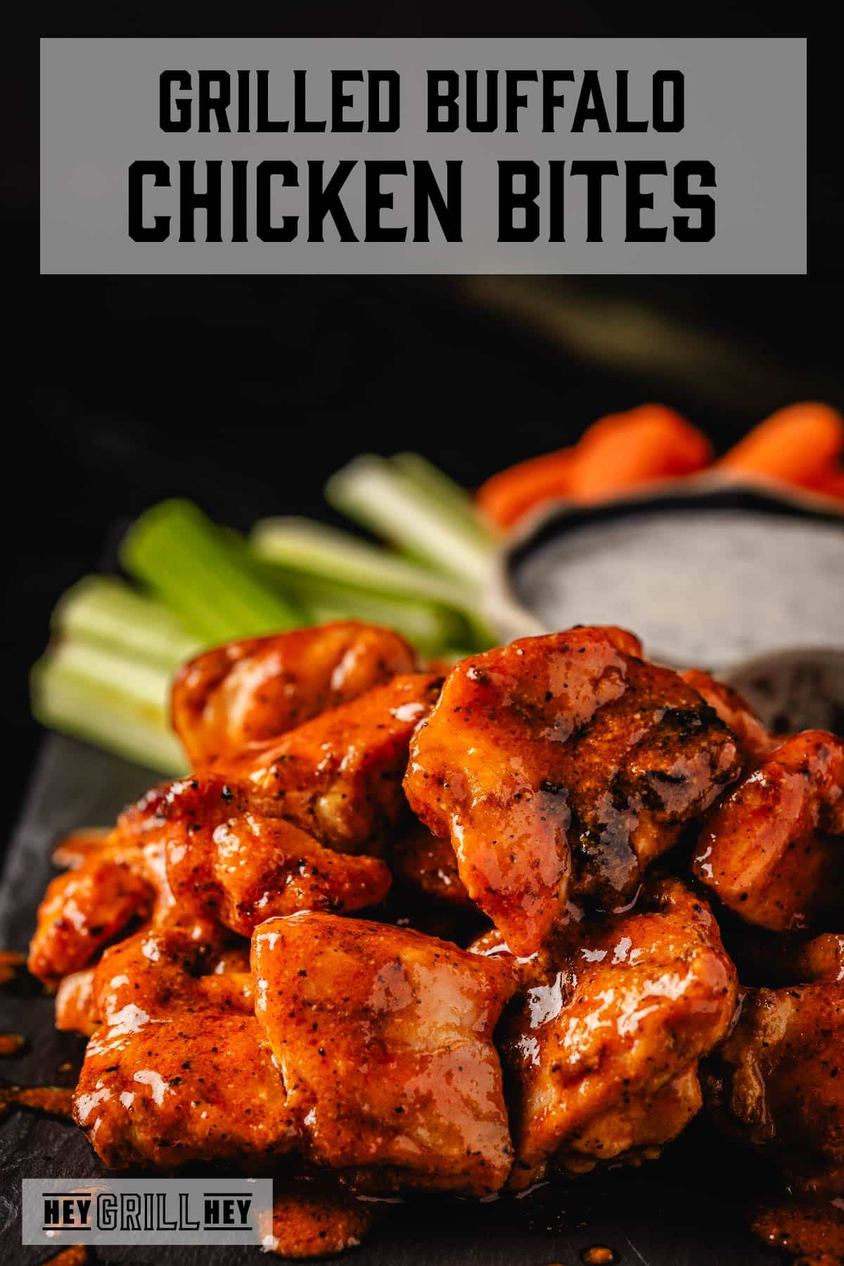 Grilled buffalo chicken bites next to carrot and celery sticks, and a bowl of ranch. Text reads "Grilled Buffalo Chicken Bites."