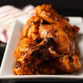 Buffalo wings on white serving platter.