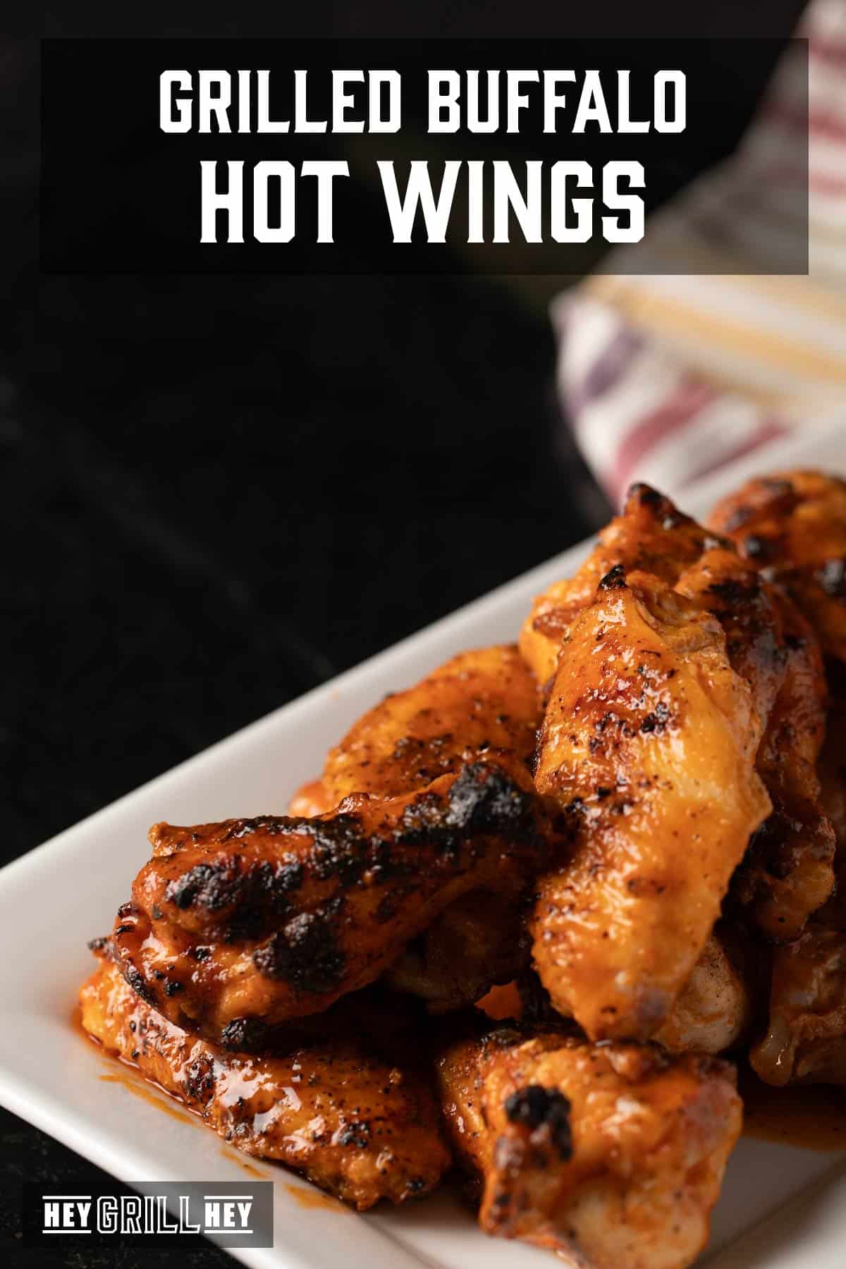 Buffalo wings on white platter. Text reads "Grilled Buffalo Hot Wings."