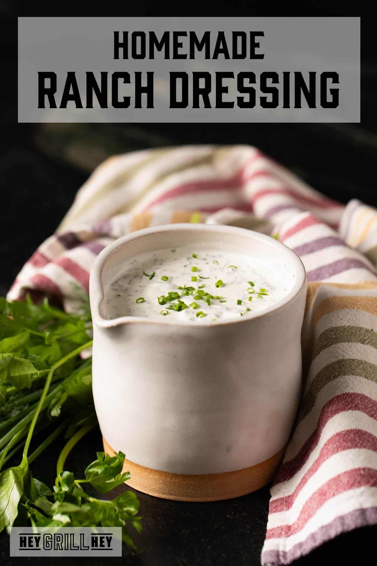 Ranch dressing in white jar next to cloth napkin and fresh dill. Text reads "Homemade Ranch Dressing."