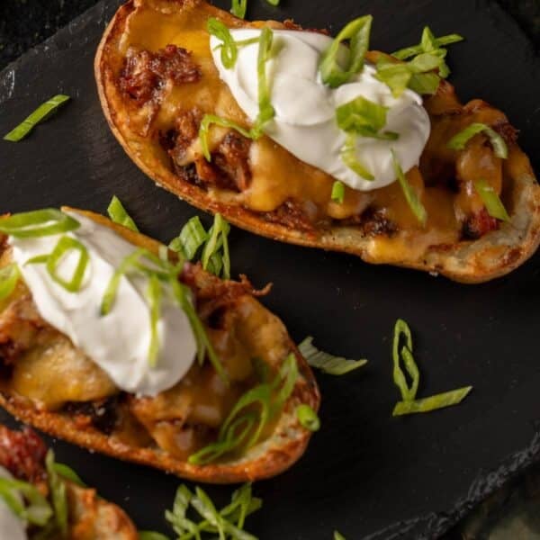 Potato skins filled with pulled pork, cheese, and sour cream.