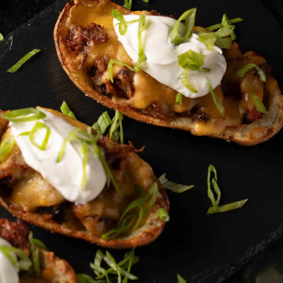 Potato skins filled with pulled pork, cheese, and sour cream.