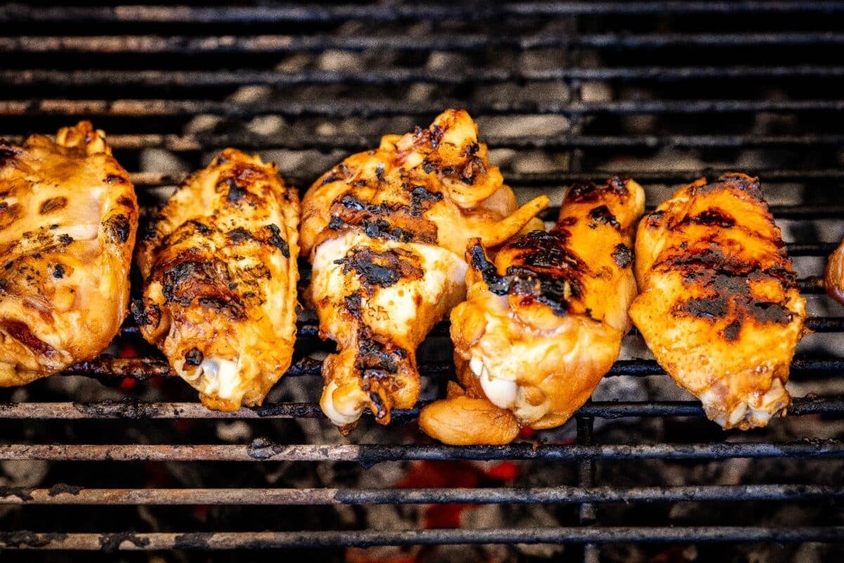 Chicken wings on grill grates.