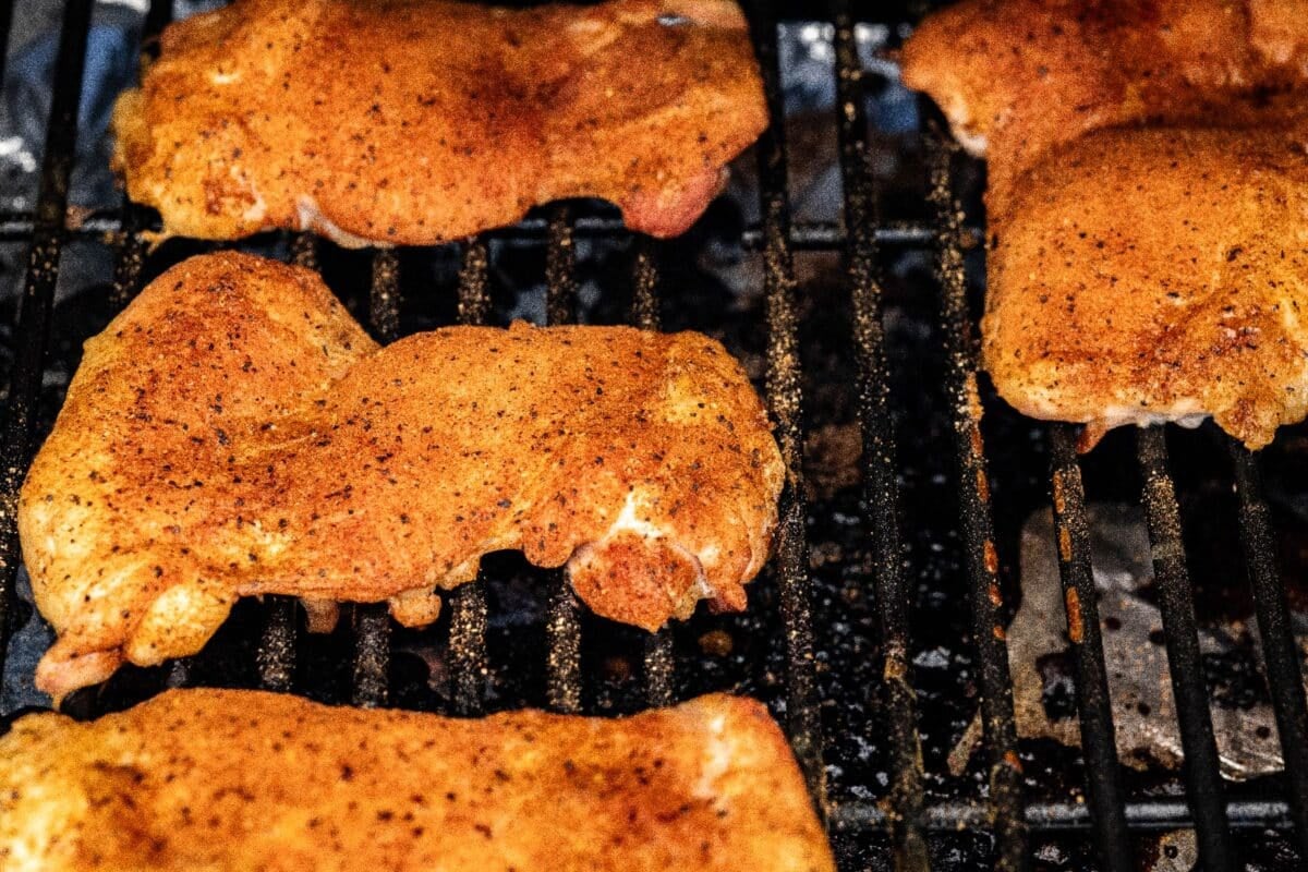 Fried chicken breasts on a cooling rack.