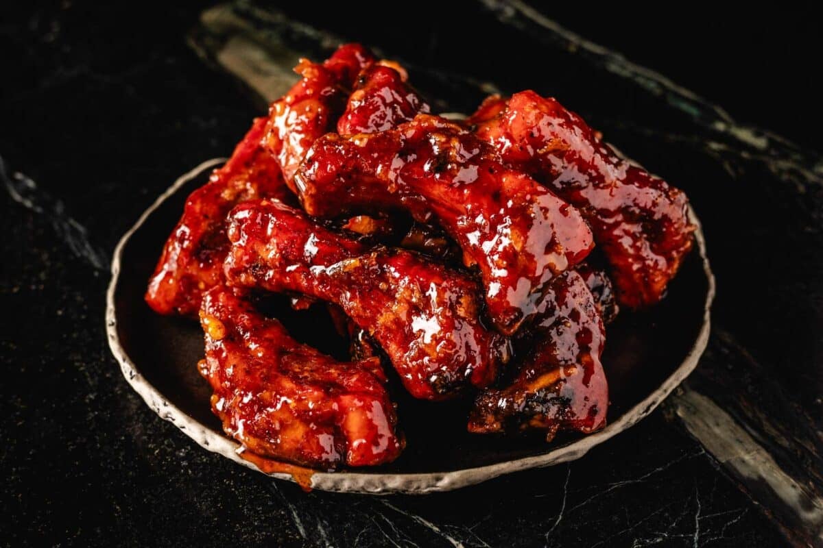 Glazed party ribs on plate on countertop.